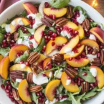 Vibrant pomegranate salad with greens, feta cheese, and seasonal fruits.