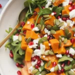 Vibrant butternut squash salad with roasted squash, pomegranates, and pecans.